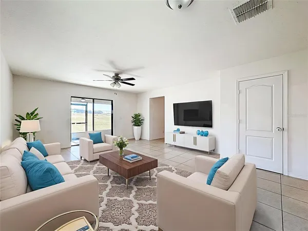 a living room with furniture and a flat screen tv