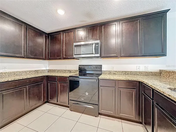a kitchen with a sink and a stove top oven