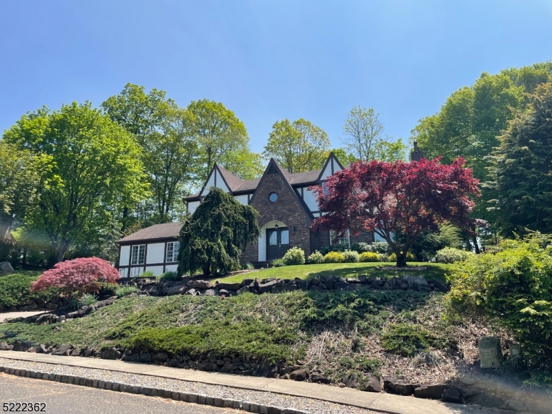 a view of a house with a backyard and a garden