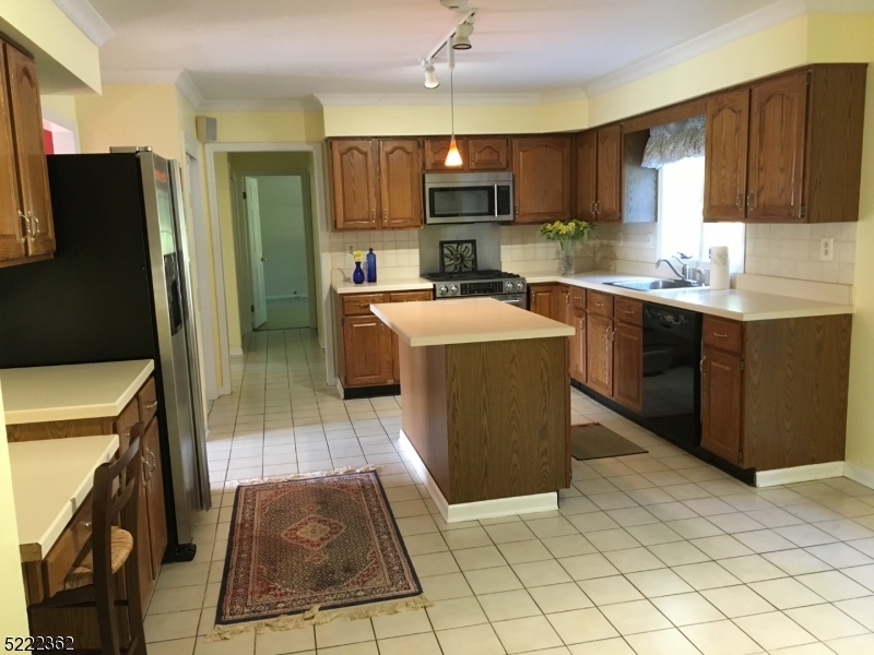 87 Highland Circle Berkeley Heights, NJ 07922 - Photo 5 of 11 a kitchen with stainless steel appliances granite countertop a refrigerator a stove top oven and a sink