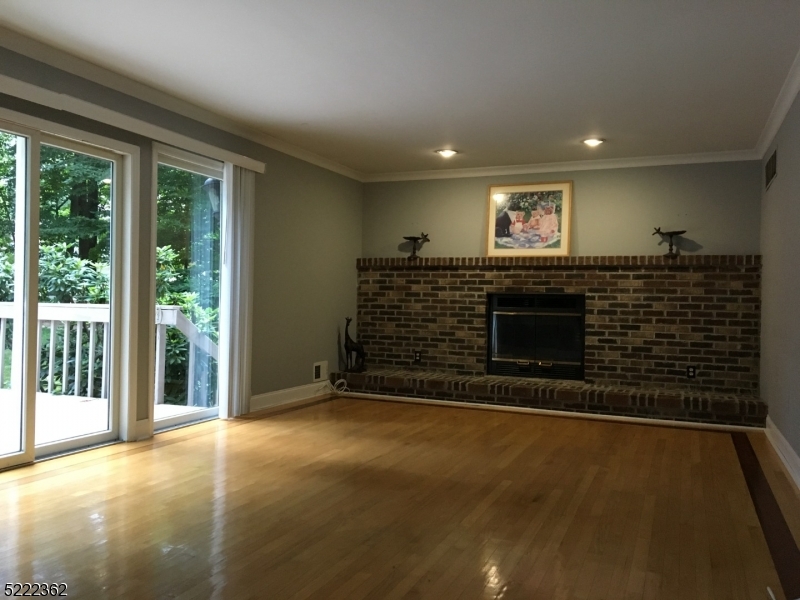 87 Highland Circle Berkeley Heights, NJ 07922 - Photo 6 of 11 a view of an empty room with a fireplace and a window