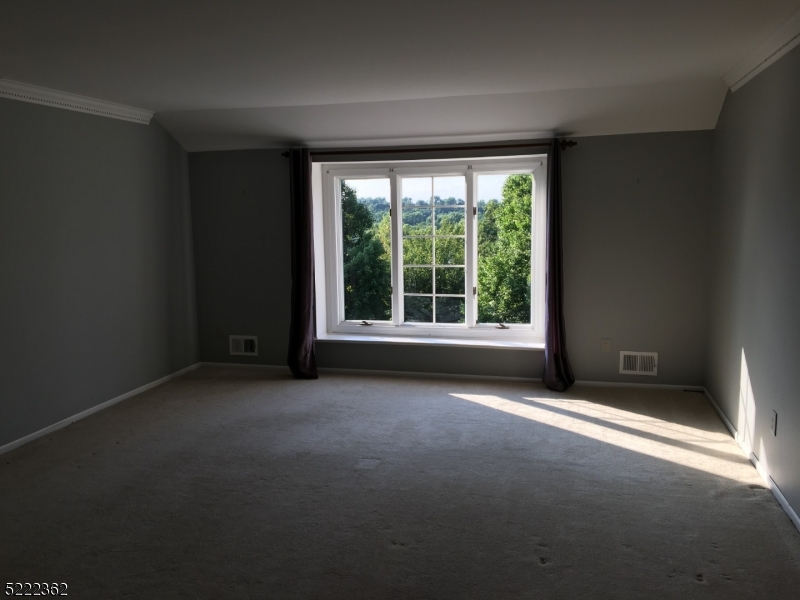 87 Highland Circle Berkeley Heights, NJ 07922 - Photo 9 of 11 an empty room with large windows