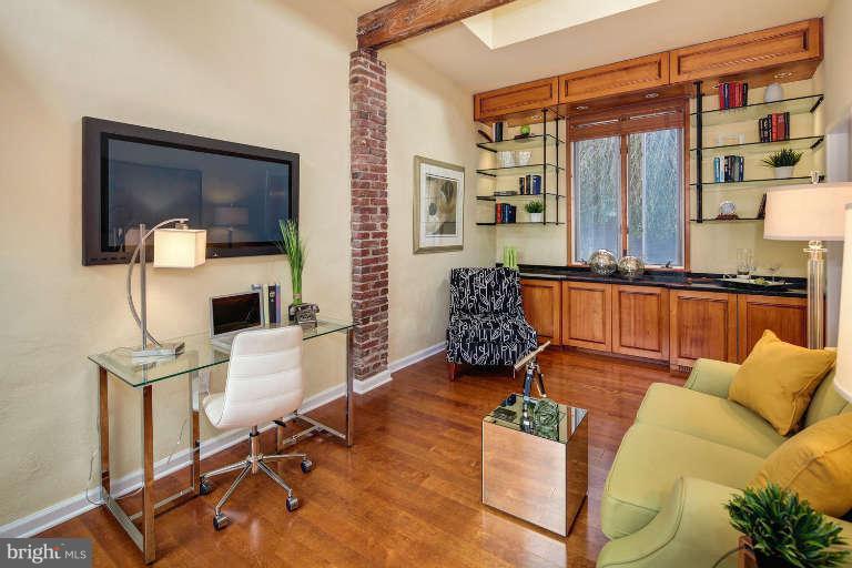 2113 37th Street Northwest Washington, DC 20007 - Photo 13 of 30 a living room with furniture a flat screen tv and a floor to ceiling window