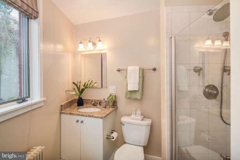 2113 37th Street Northwest Washington, DC 20007 - Photo 16 of 30 a bathroom with a granite countertop sink toilet and shower