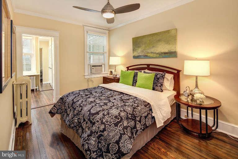 2113 37th Street Northwest Washington, DC 20007 - Photo 17 of 30 a bedroom with a bed and wooden floor