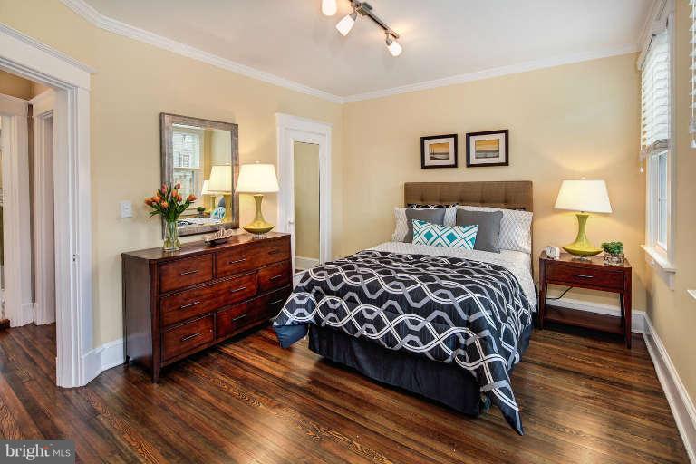 2113 37th Street Northwest Washington, DC 20007 - Photo 20 of 30 a bedroom with a bed and wooden floor