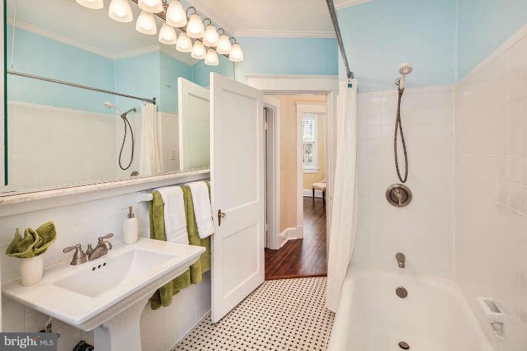 2113 37th Street Northwest Washington, DC 20007 - Photo 23 of 30 a bathroom with a sink vanity mirror and shower