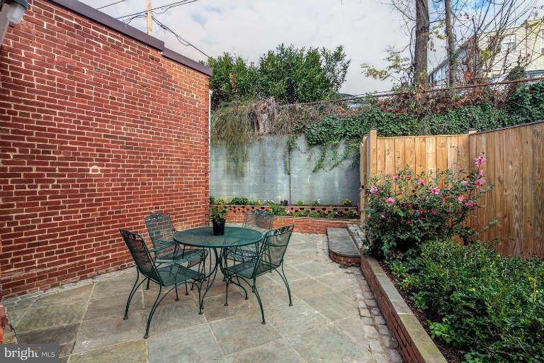 2113 37th Street Northwest Washington, DC 20007 - Photo 27 of 30 a backyard of a house with table and chairs plants