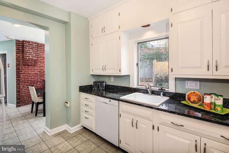 2113 37th Street Northwest Washington, DC 20007 - Photo 10 of 30 a kitchen with granite countertop a sink stove and cabinets