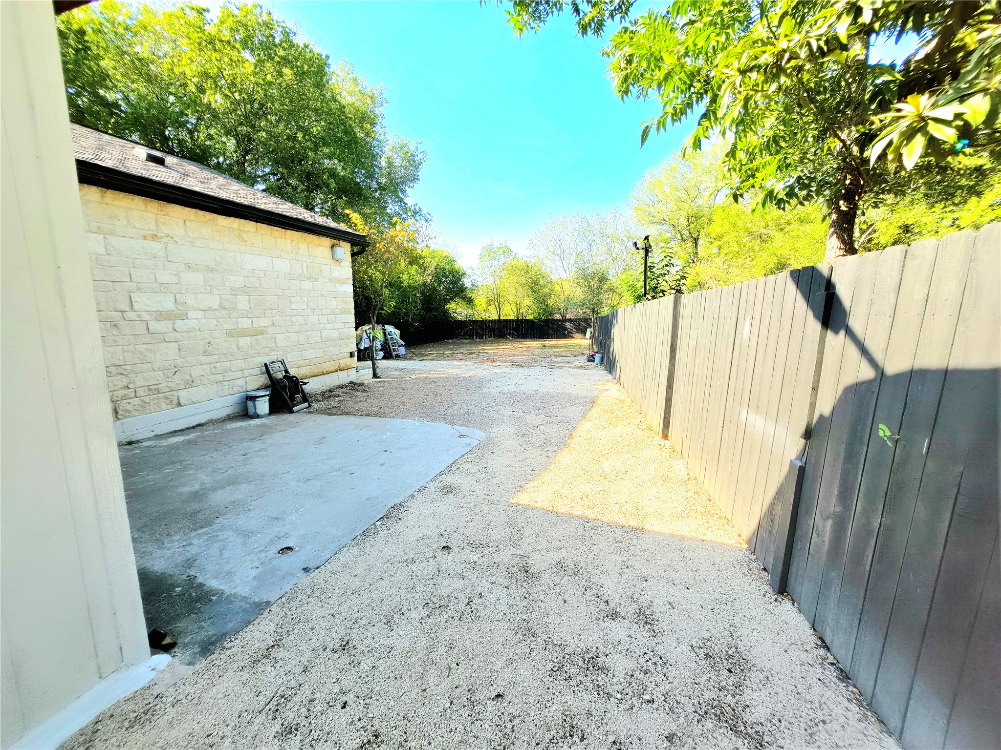 2201 Teri Road Austin, TX 78744 - Photo 29 of 40 Mature trees shade a spacious outdoor area bordered by secure perimeter fencing.