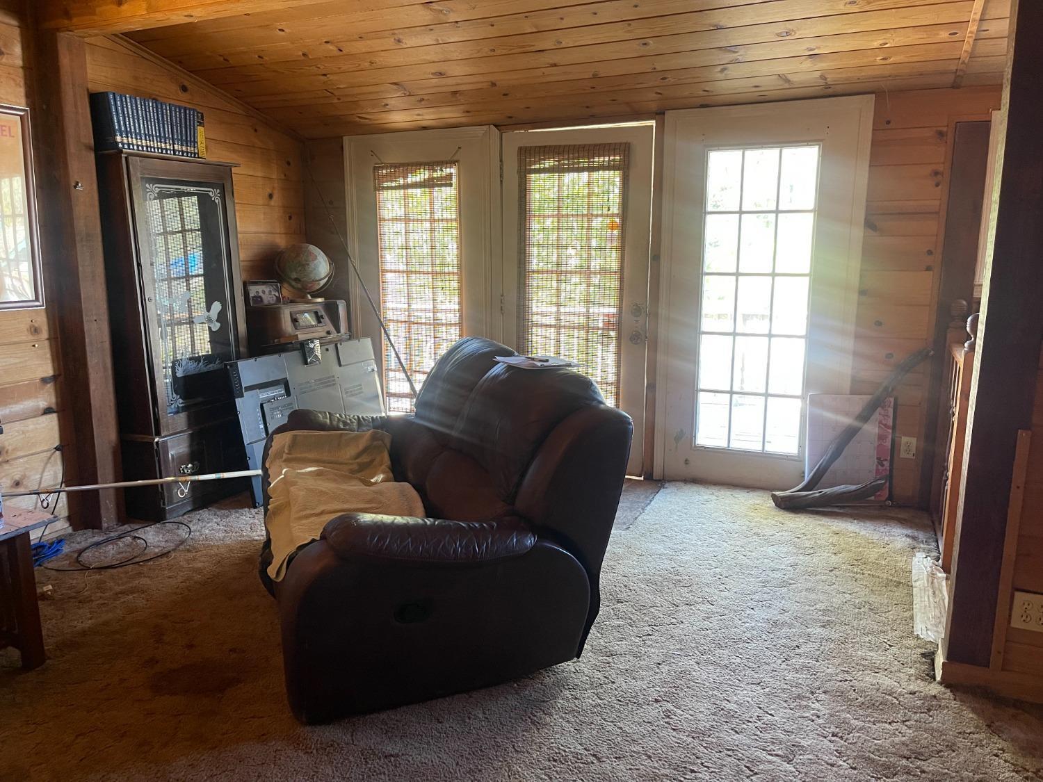 219 Hinchey Lane Colfax, CA 95713 - Photo 9 of 9 a living room with furniture and a floor to ceiling window
