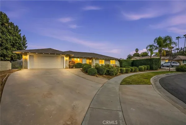 a view of a house with a yard and a garage