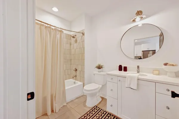 a bathroom with a sink a toilet and a mirror