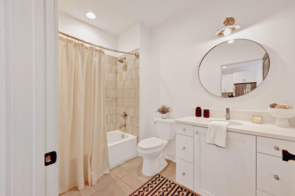 14 Becker Place Northwest Atlanta, GA 30307 - Photo 13 of 24 a bathroom with a sink a toilet and a mirror
