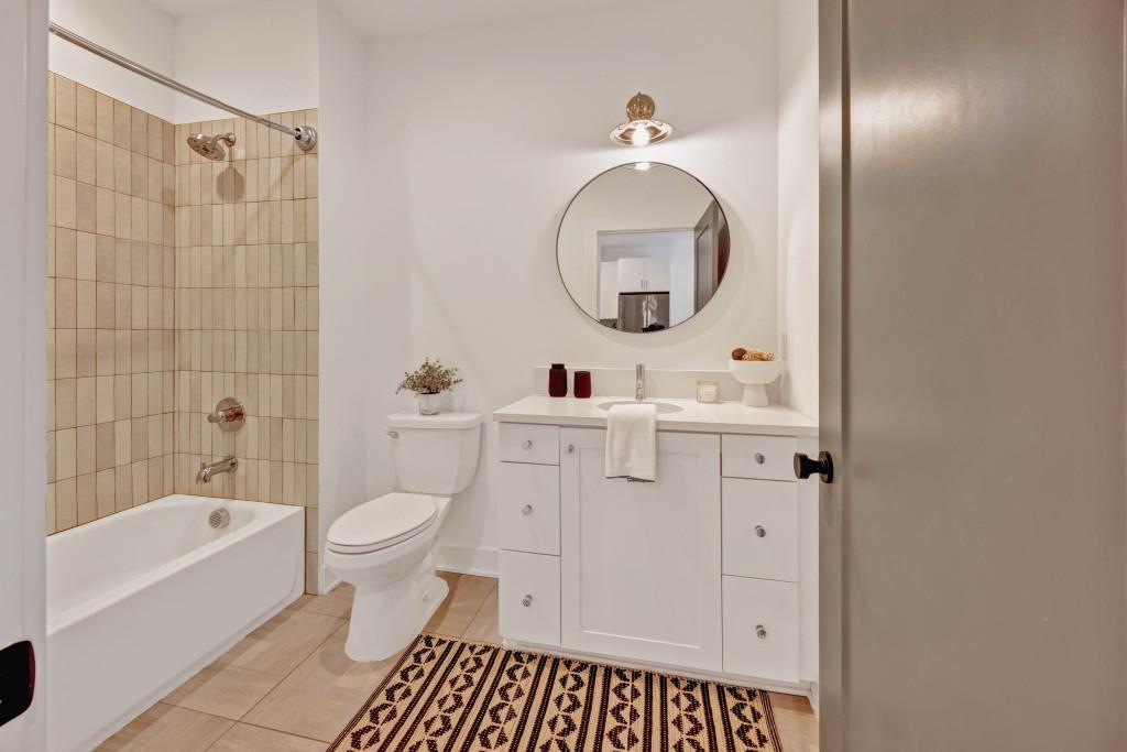 14 Becker Place Northwest Atlanta, GA 30307 - Photo 14 of 24 a bathroom with a sink a toilet and a mirror