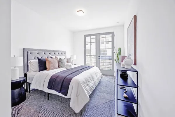 a bed room with a bed and a night stand