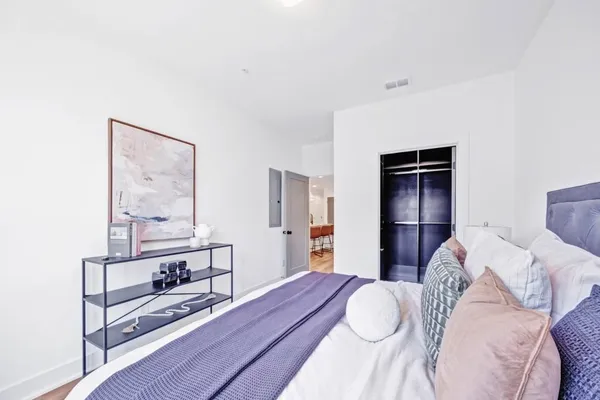 a bedroom with a bed and a table