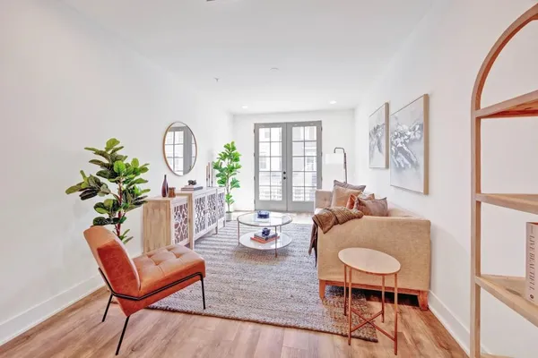 a living room with furniture a rug and a window