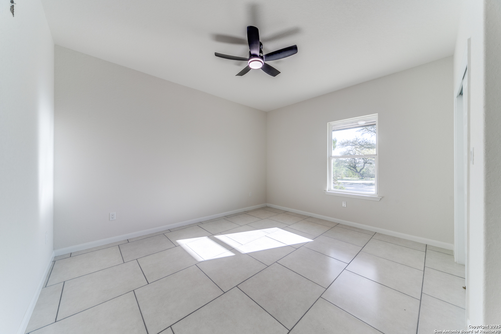 2962 Contour Drive Spring Branch, TX 78070 - Photo 14 of 26 an empty room with windows and ceiling fan
