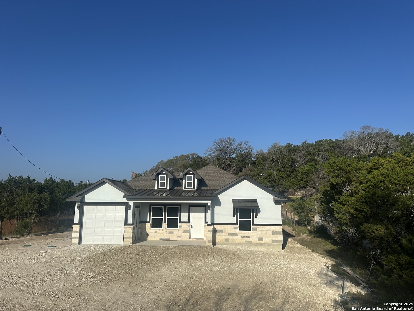 2962 Contour Drive Spring Branch, TX 78070 - Photo 2 of 26 a front view of a house with a garden and yard