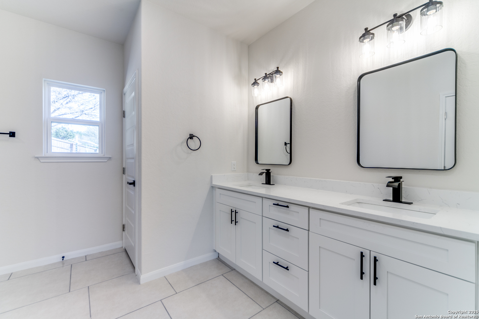 2962 Contour Drive Spring Branch, TX 78070 - Photo 22 of 26 a bathroom with double vanity sinks and a mirror