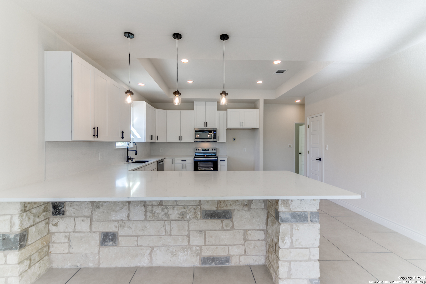 2962 Contour Drive Spring Branch, TX 78070 - Photo 6 of 26 a large kitchen with stainless steel appliances kitchen island granite countertop a sink a stove a counter space and cabinets