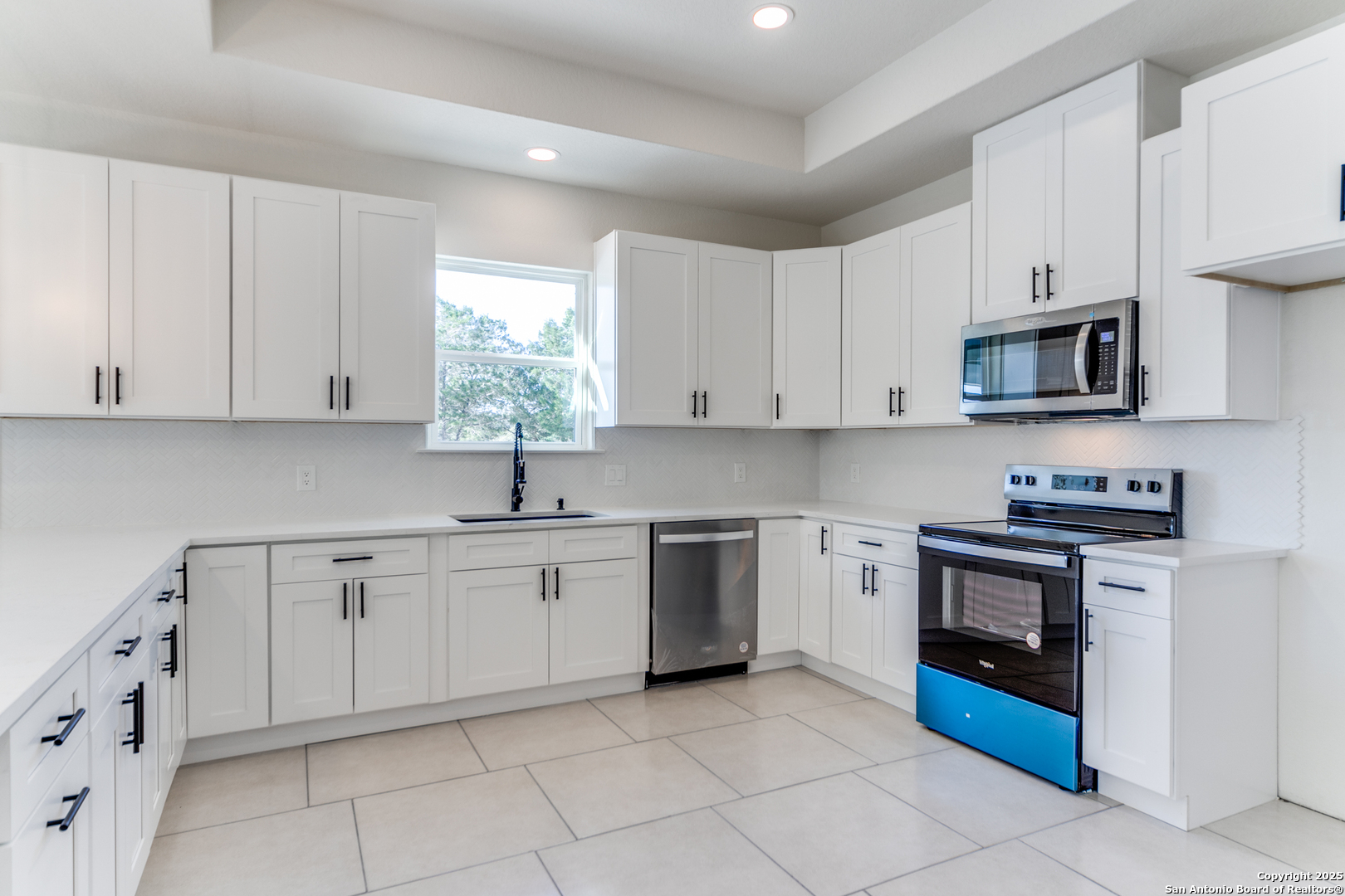 2962 Contour Drive Spring Branch, TX 78070 - Photo 8 of 26 a kitchen with cabinets appliances a sink and a window