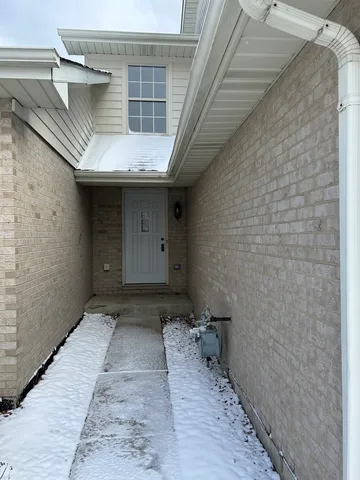 a view of front door with wooden floor