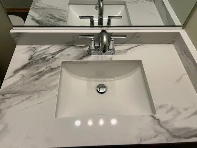 a bathroom with a sink toilet vanity and shower