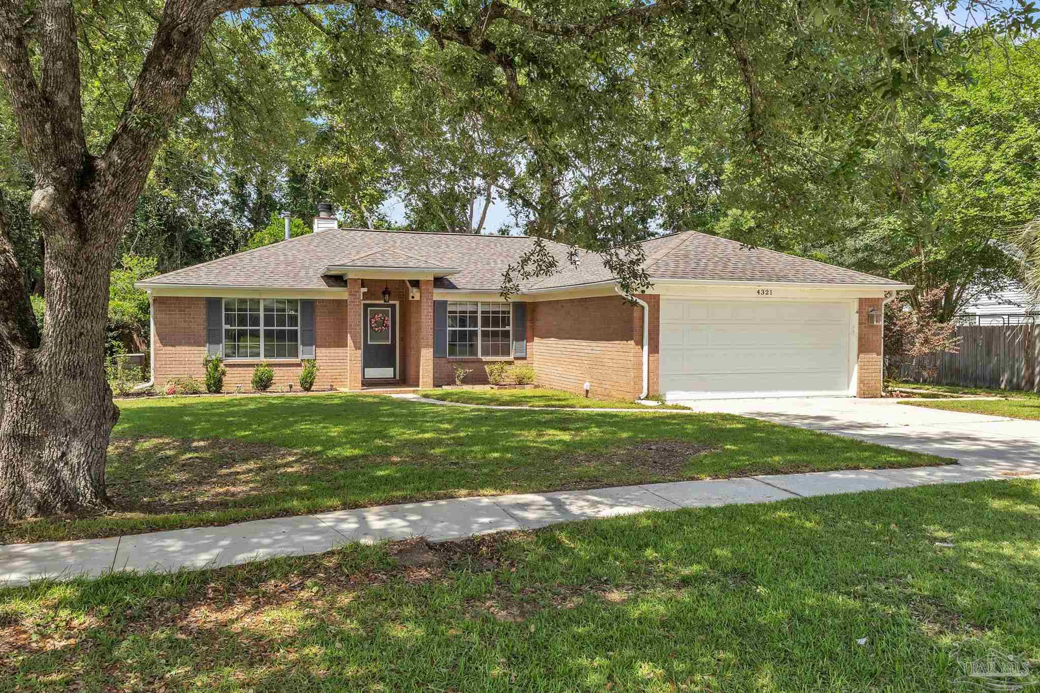 4321 Ridgeland Drive Pace, FL 32571 - Photo 1 of 36 a front view of a house with a garden