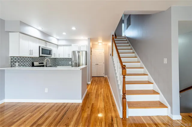 a view of kitchen with sink microwave and cabinets