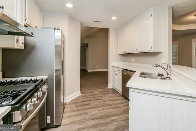 a kitchen with a stove and a refrigerator