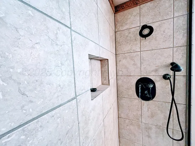 a view of an empty room with a fireplace and a window