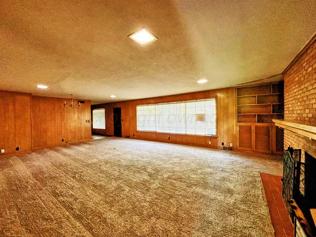 a view of an empty room with a fireplace