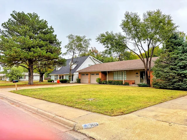 a view of a hallway with wooden floor and glass door