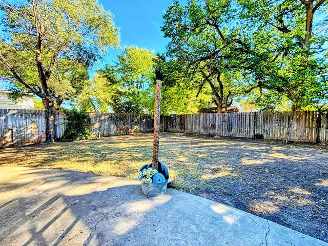 a front view of house with yard and trees