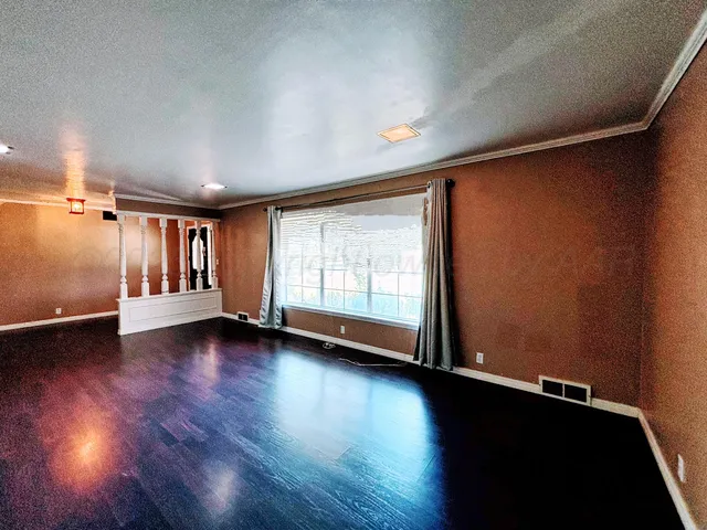a view of room with window and hardwood floor