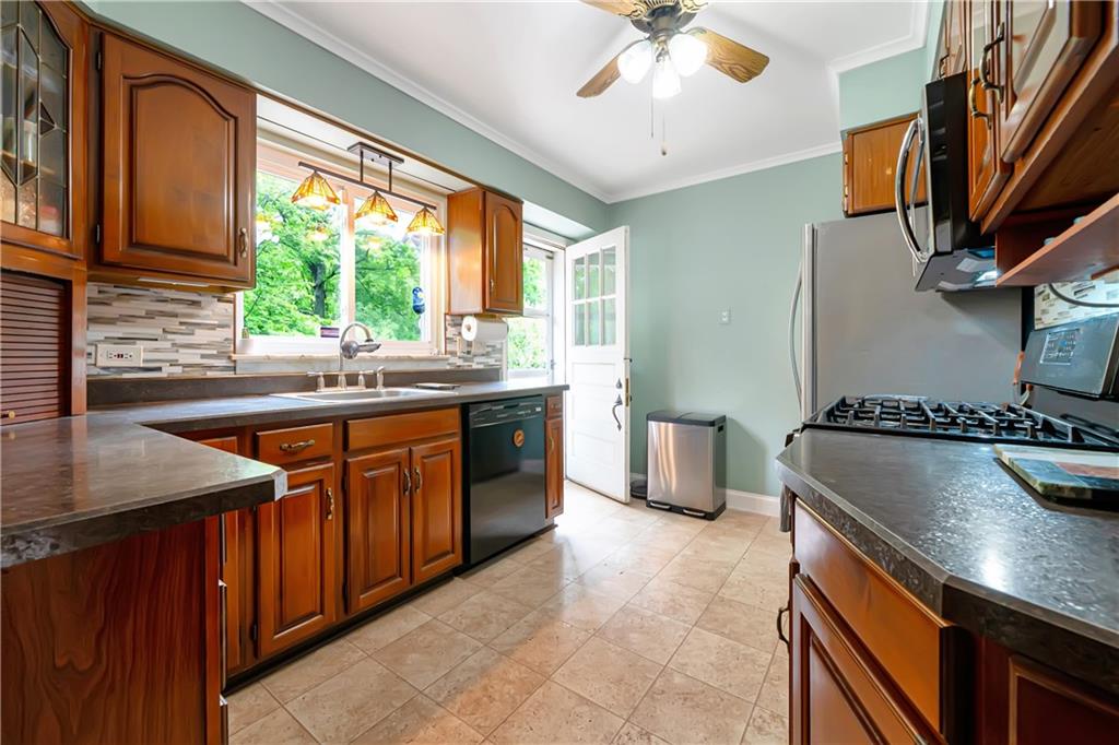 166 Spring Grove Road Pittsburgh, PA 15235 - Photo 15 of 41 a kitchen with stainless steel appliances granite countertop a sink a stove and a refrigerator