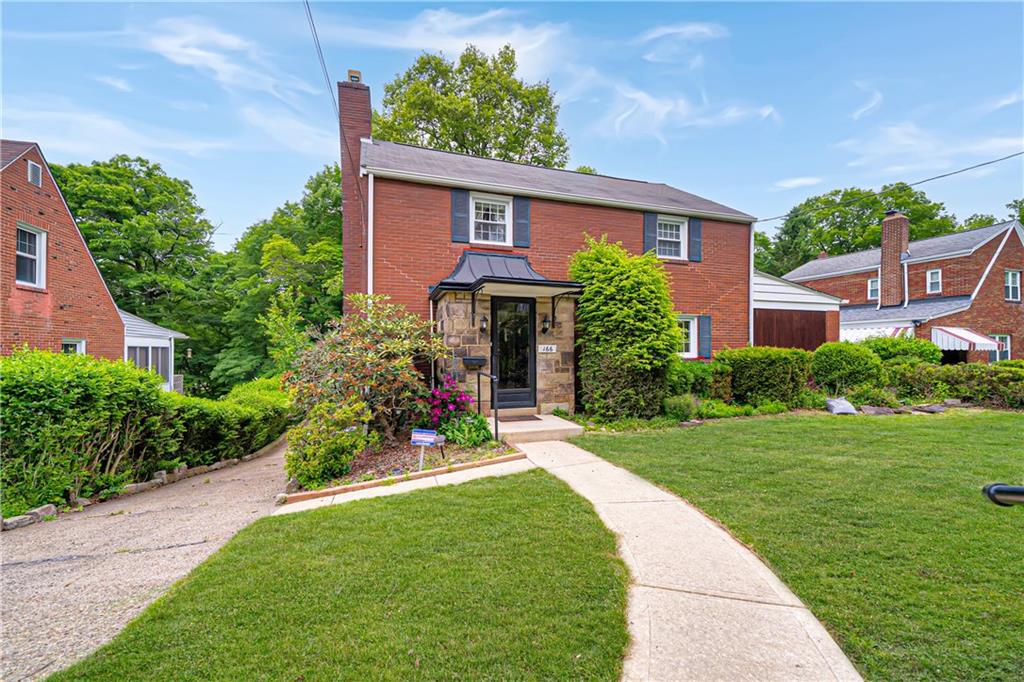 166 Spring Grove Road Pittsburgh, PA 15235 - Photo 2 of 41 a front view of a house with a yard