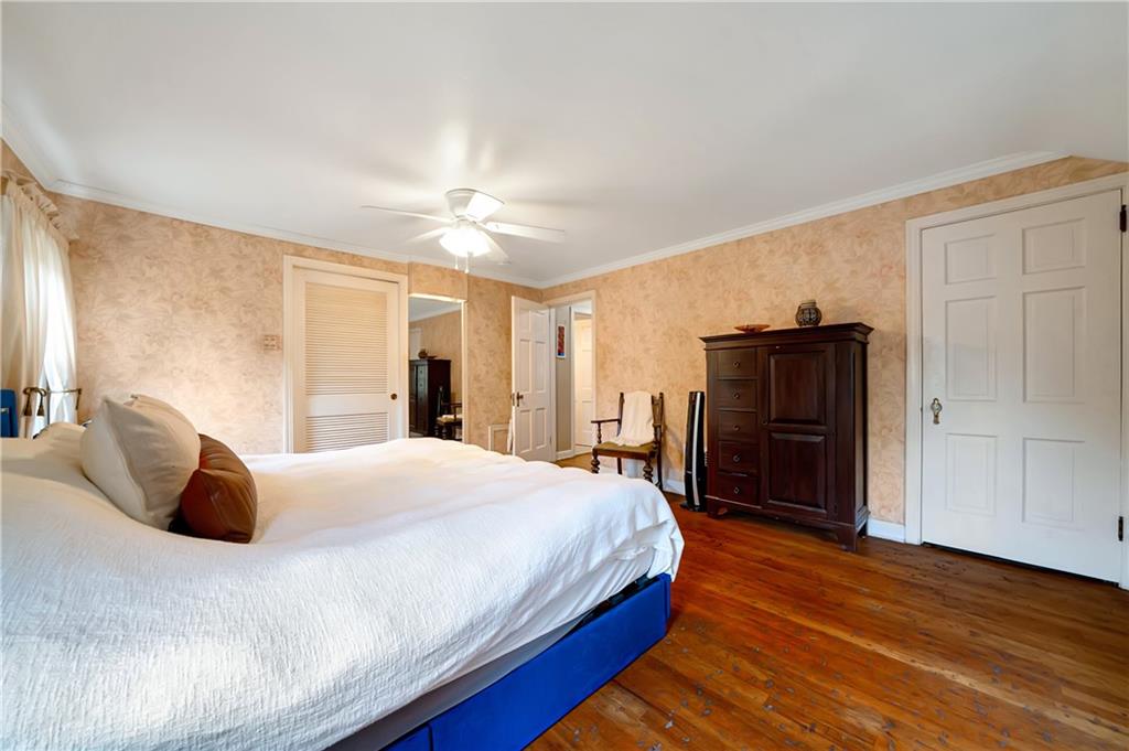 166 Spring Grove Road Pittsburgh, PA 15235 - Photo 21 of 41 a bedroom with a bed and wooden floor