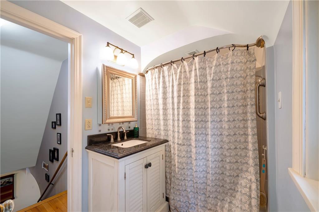 166 Spring Grove Road Pittsburgh, PA 15235 - Photo 27 of 41 a bathroom with a granite countertop sink a mirror and a shower