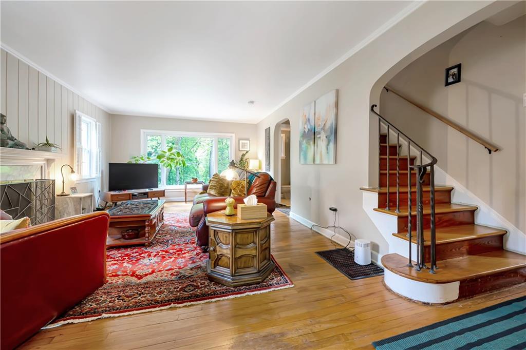 166 Spring Grove Road Pittsburgh, PA 15235 - Photo 3 of 41 a living room with fireplace furniture and a wooden floor