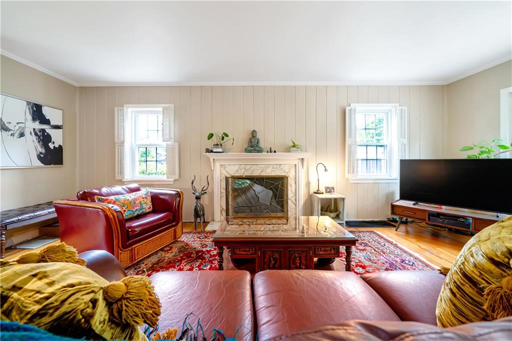166 Spring Grove Road Pittsburgh, PA 15235 - Photo 8 of 41 a living room with furniture a flat screen tv and a fireplace