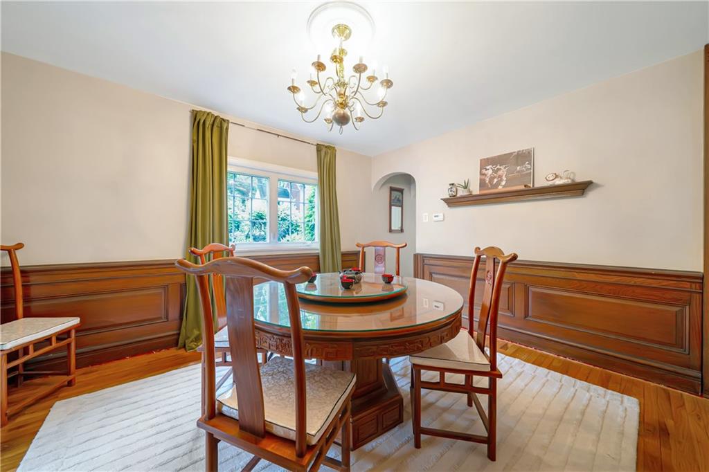 166 Spring Grove Road Pittsburgh, PA 15235 - Photo 10 of 41 a view of a dining room with furniture a chandelier and wooden floor