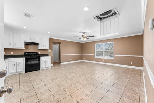 a kitchen with granite countertop a sink cabinets and stainless steel appliances