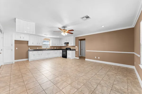a view of a kitchen with kitchen microwave and cabinets