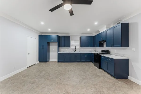 an empty room with a window and a fan