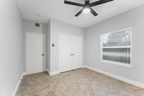 a view of a white house in middle of the green field
