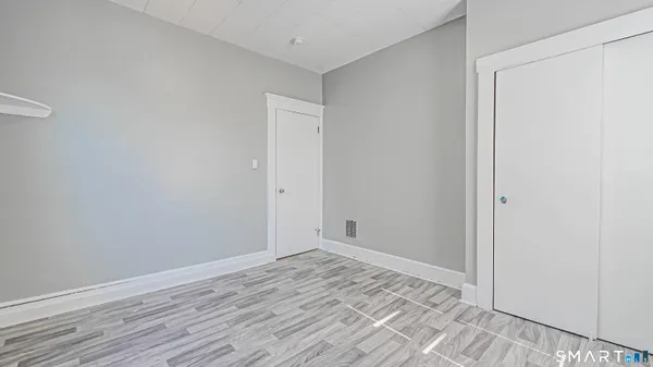 a view of a room with wooden floor