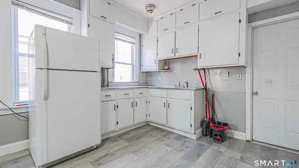 a kitchen with refrigerator and window